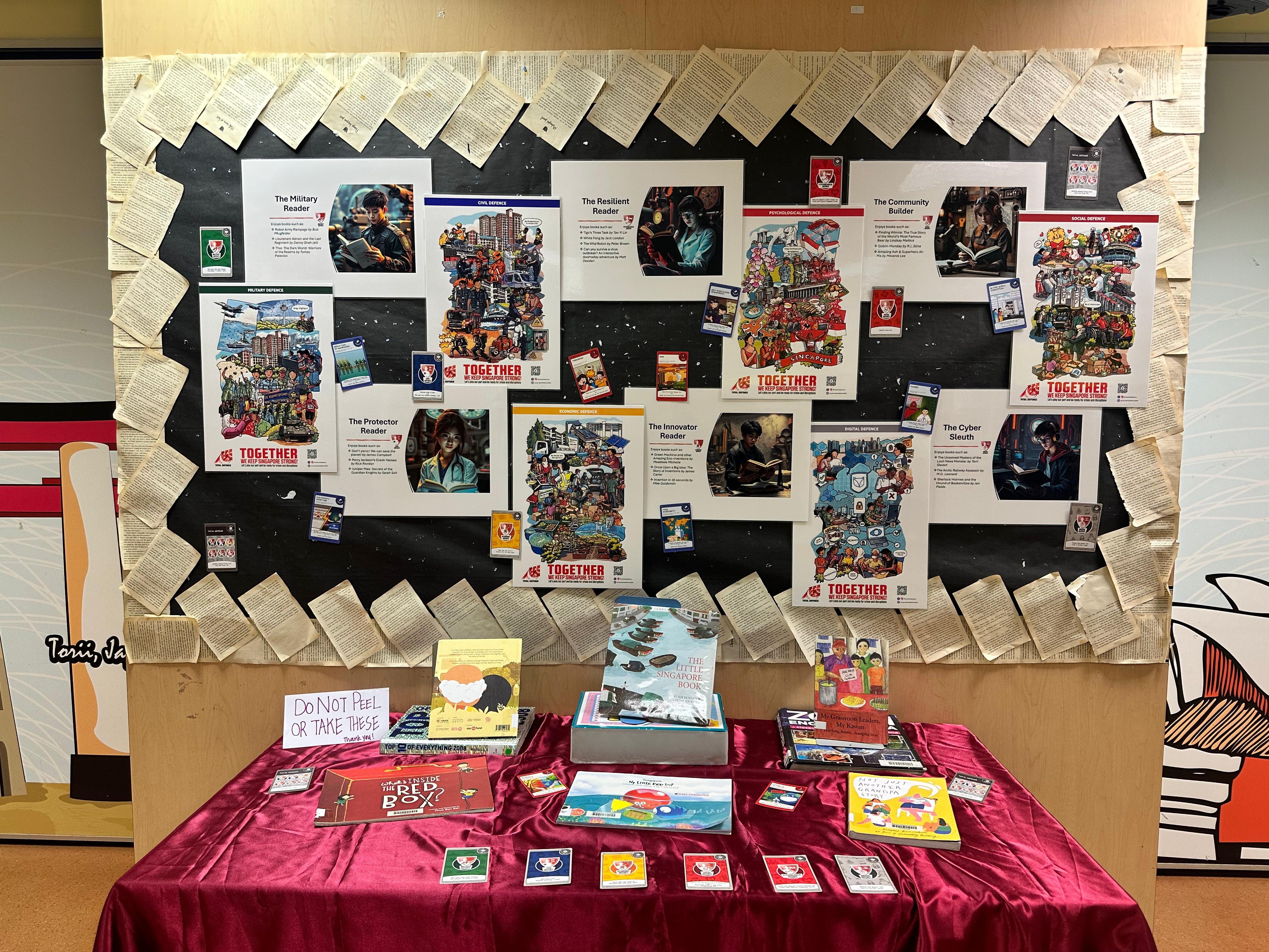 A dedicated library display showcasing books and essential facts to help students deepen their understanding of Total Defence.